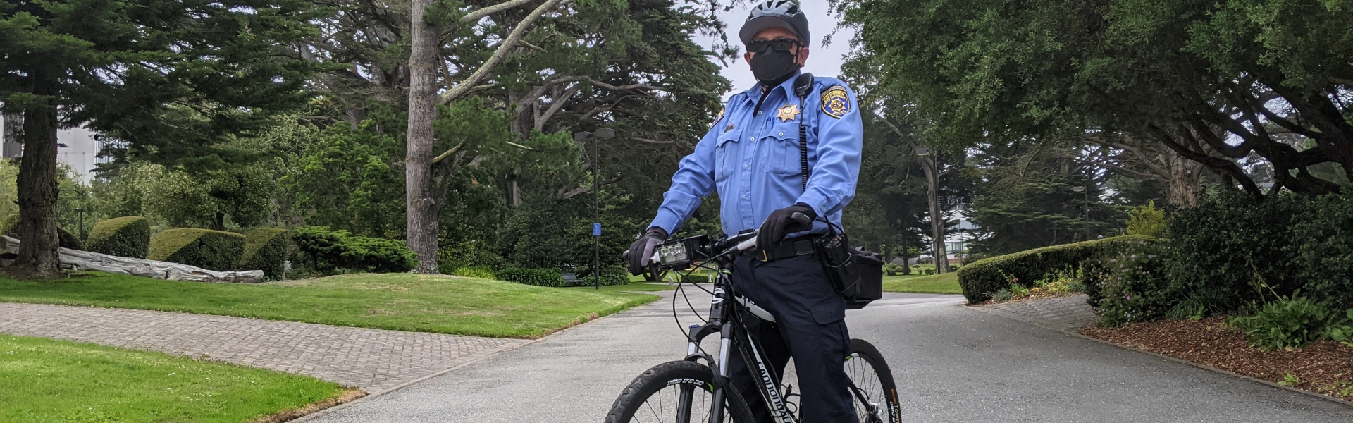 UPD Community Service Specialist on bicycle patrol on campus