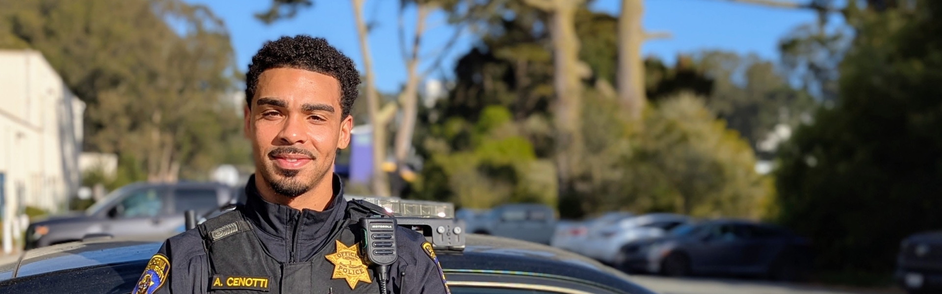 Image of UPD officer standing near his patrol vehicle 