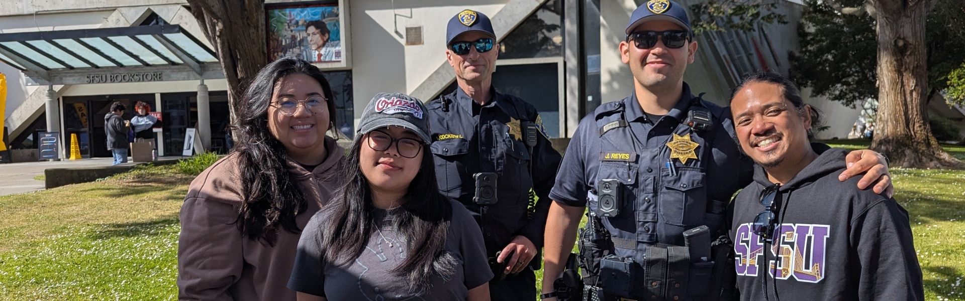 Image of members of the Division of Campus Safety at a tabling event in the SFSU quad