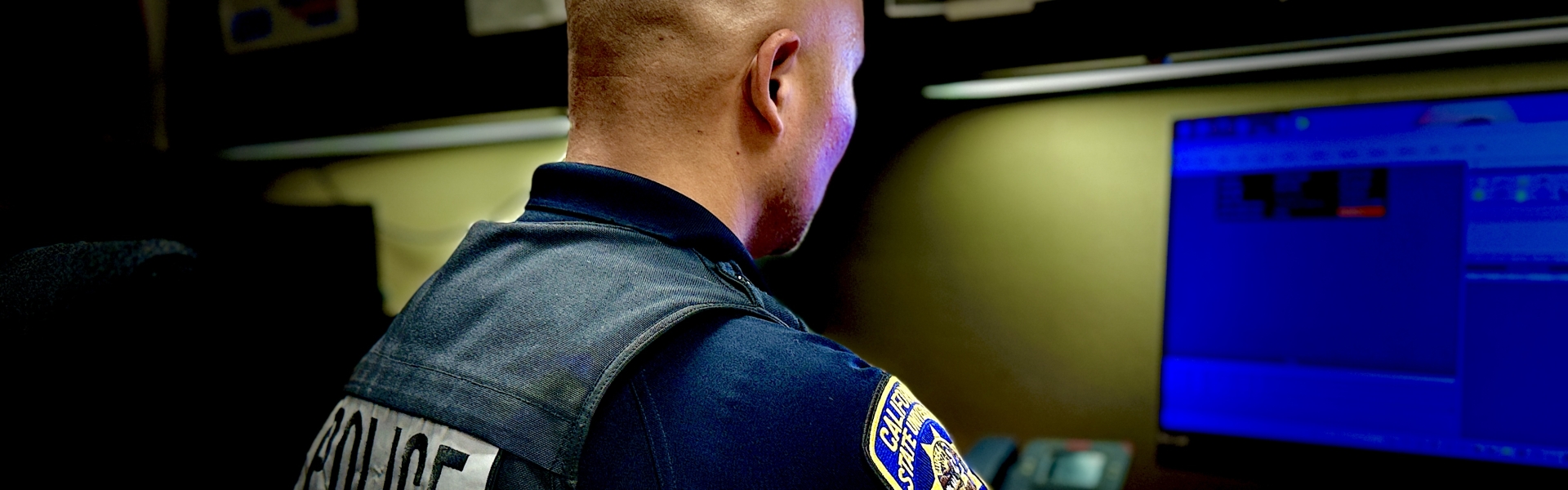 Image of a police officer writing a report.