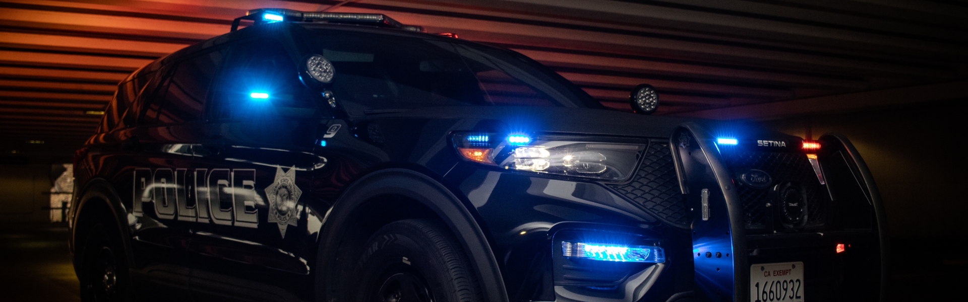 Image of UPD SUV in a parking lot with lights on